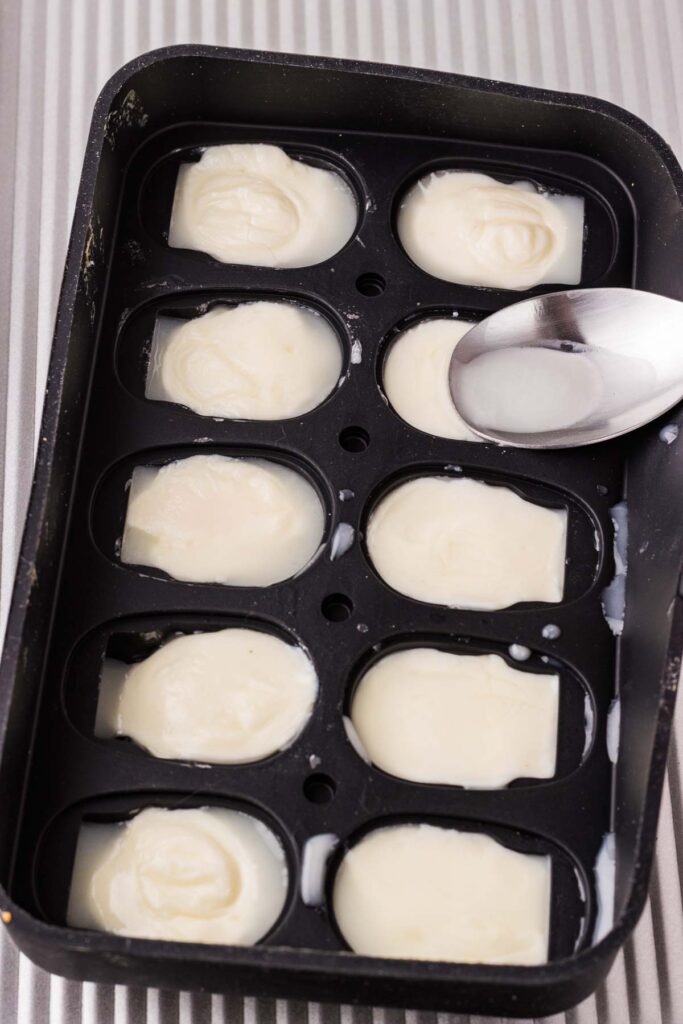Mozzarella being molded in a skull mold.