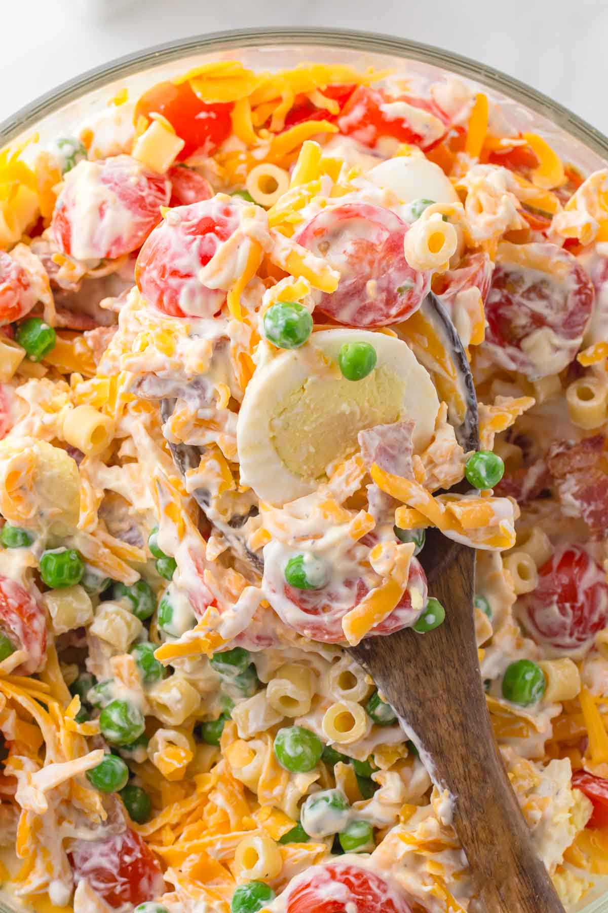 7 layer salad with pasta after it's been tossed with the dressing.