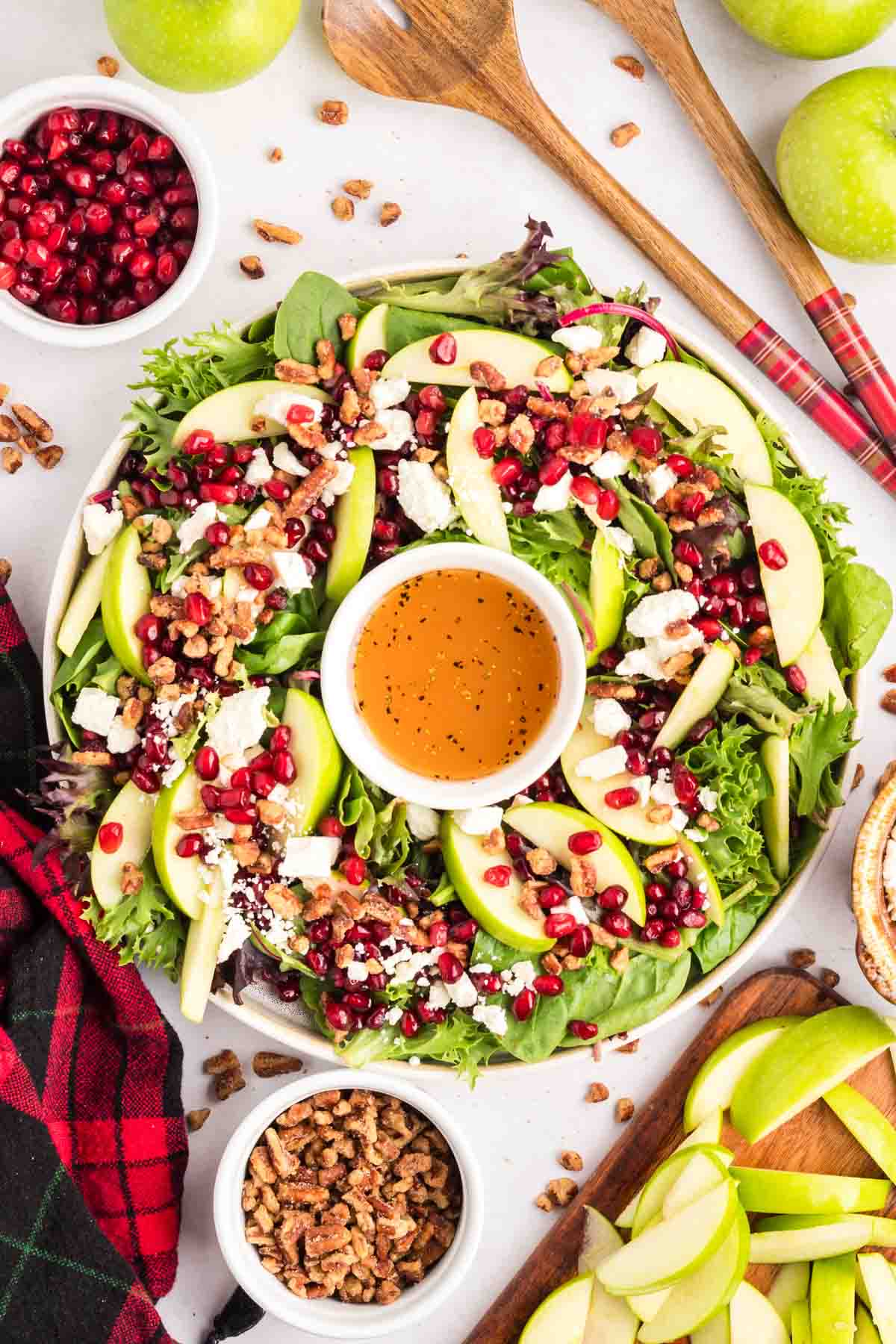 Christmas salad in a wreath shape on a white platter.