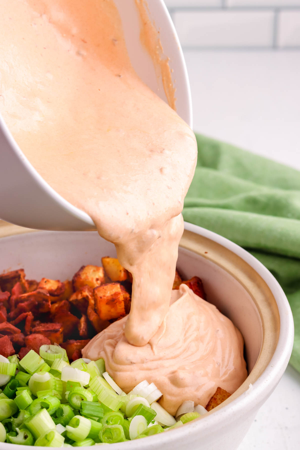 Creamy Southwest salad dressing being poured over a salad. 