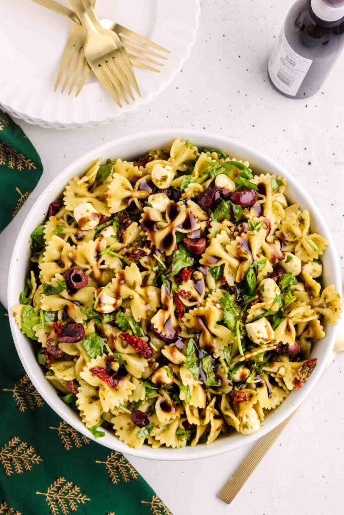 Christmas pasta salad in a serving bowl, drizzle with balsamic glaze.