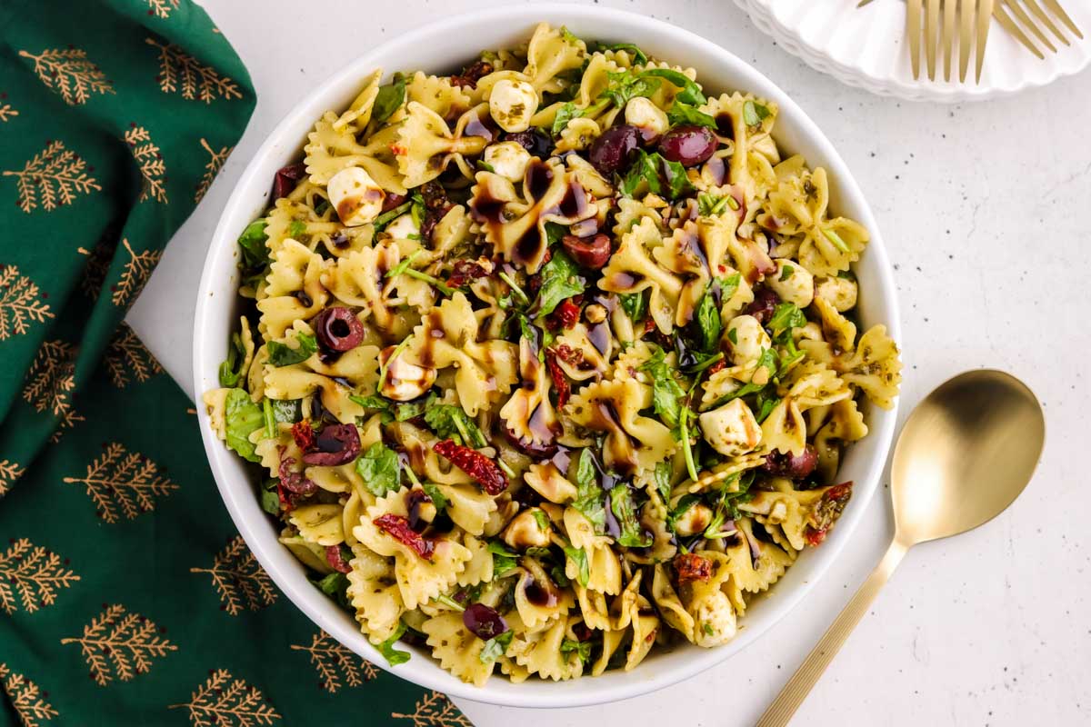 Christmas salad dressed with balsamic glaze in a white bowl.