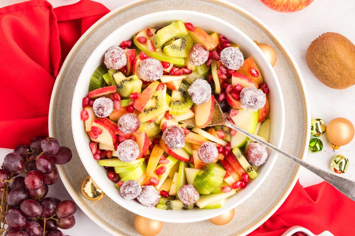 Christmas fruit salad in a white bowl.
