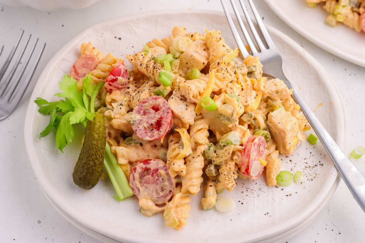 A serving plate with buffalo chicken pasta salad. 