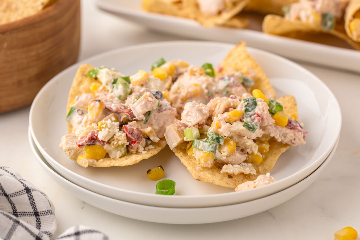 Mexican street corn chicken salad on top of tortilla chips.