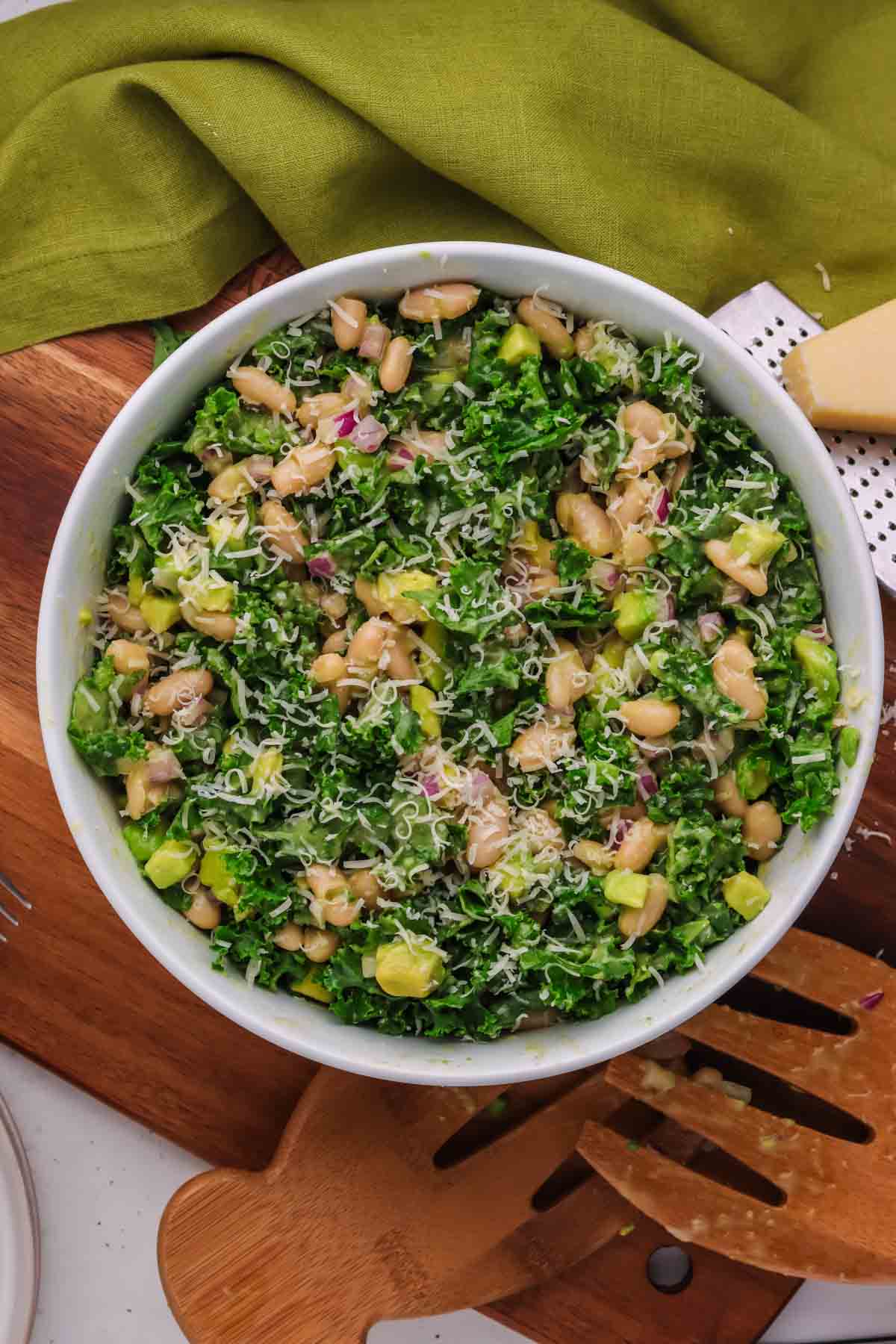 kale and white bean salad in a white bowl.