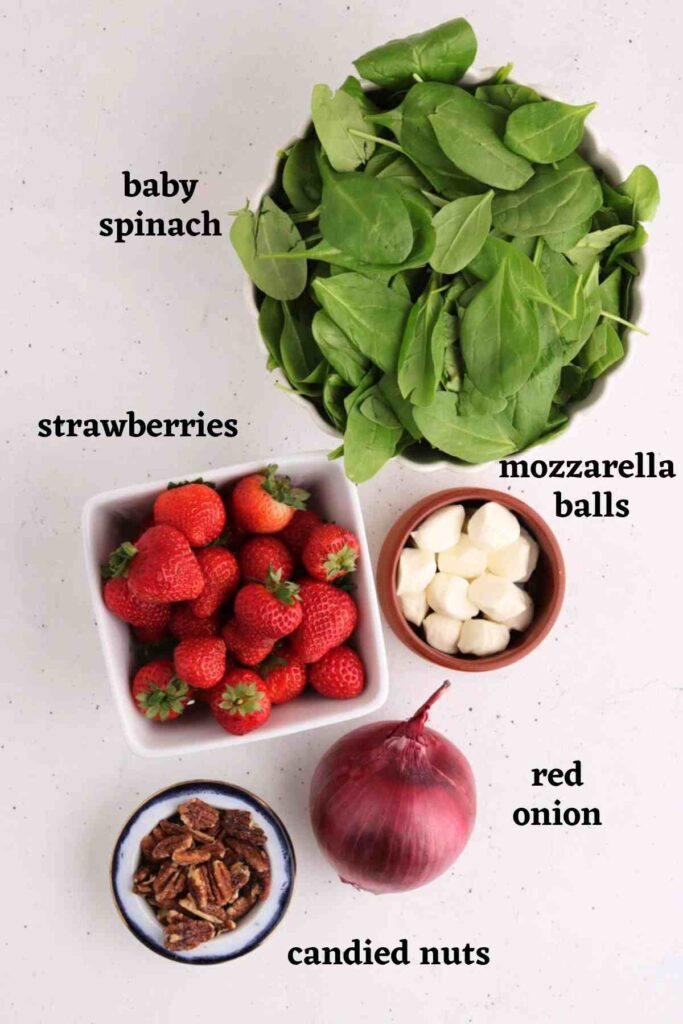 Ingredients needed to make the strawberry spinach salad with mozzarella hearts.